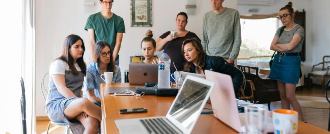 Group of young professionals with marketing expertise engaged in a collaborative meeting in a modern office setting.