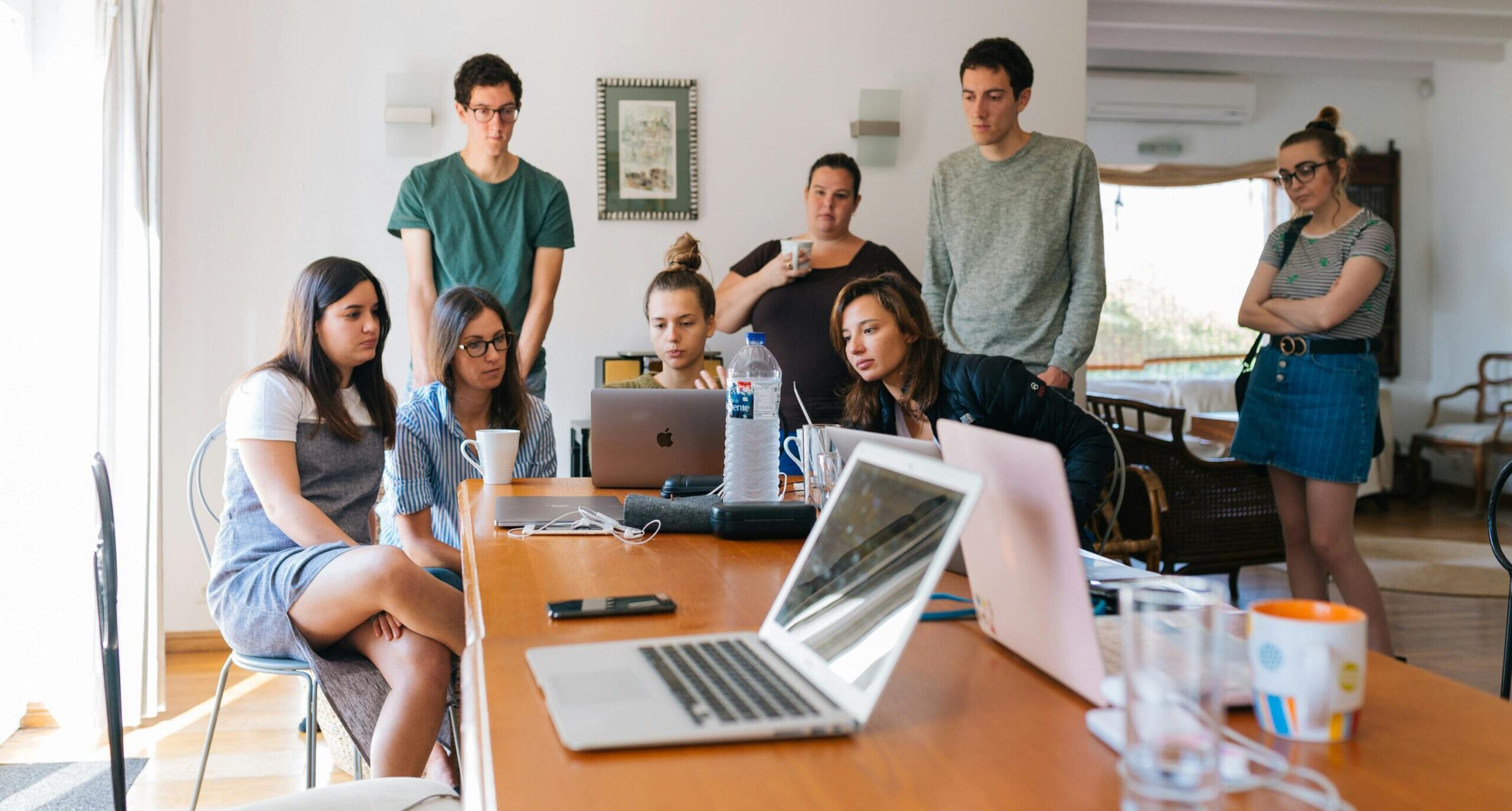 Group of young professionals with marketing expertise engaged in a collaborative meeting in a modern office setting.